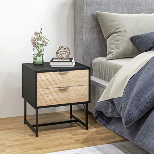 Bedroom with a nightstand next to a bed with gray and blue bedding.